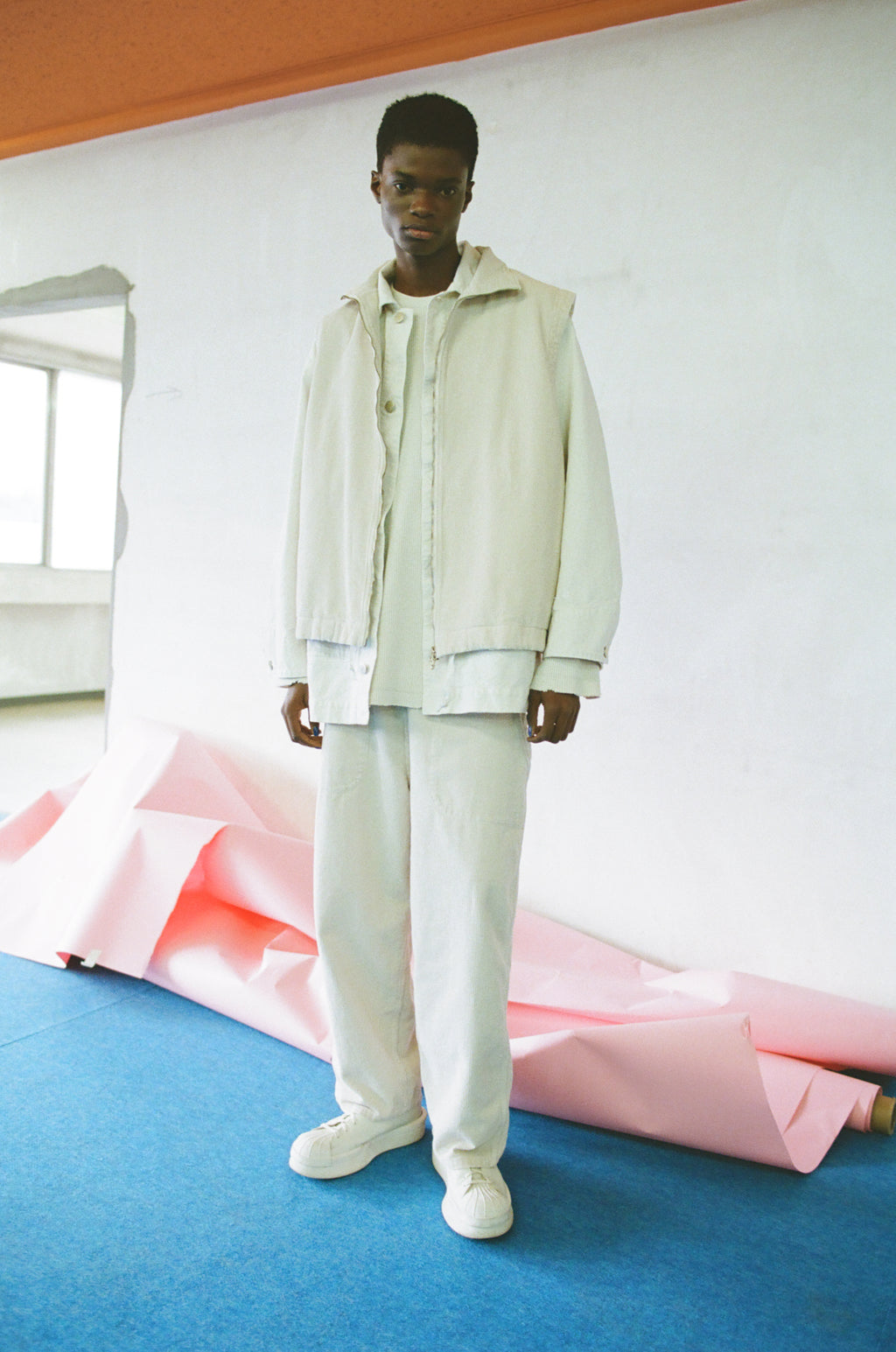 concause CORDUROY LUNCH PANTS ルックスタイリング / OFF WHITE 青い床の室内 セットアップ 立ちビュー
